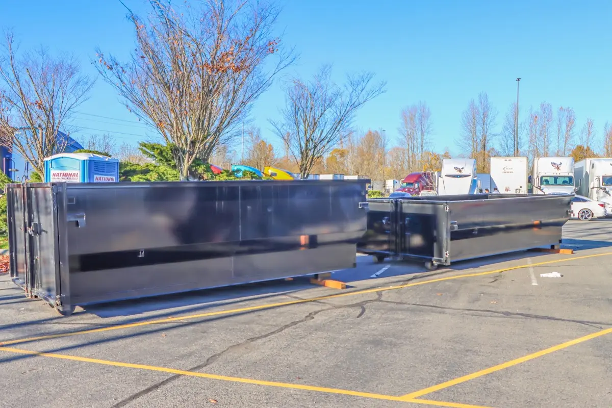 Professional dumpster rental service with roll-off container on residential driveway in Antelope